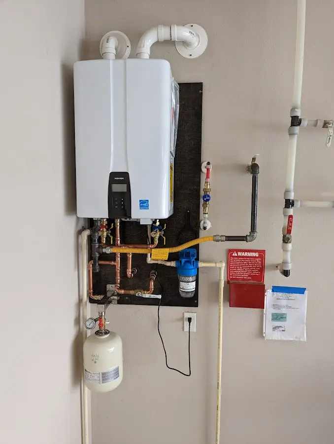 Professional plumber installing copper piping in a Bossier City home